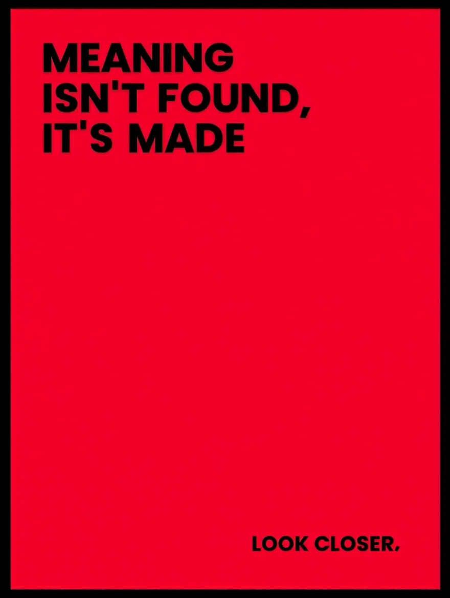 A minimalist typographic poster design featuring bold black sans-serif text against a solid red background, framed in black. The main text reads "MEANING ISN'T FOUND, IT'S MADE" with strategic hyphenation, while smaller text at the bottom states "LOOK CLOSER." The composition creates a striking visual hierarchy through size contrast and spatial arrangement of the text elements.