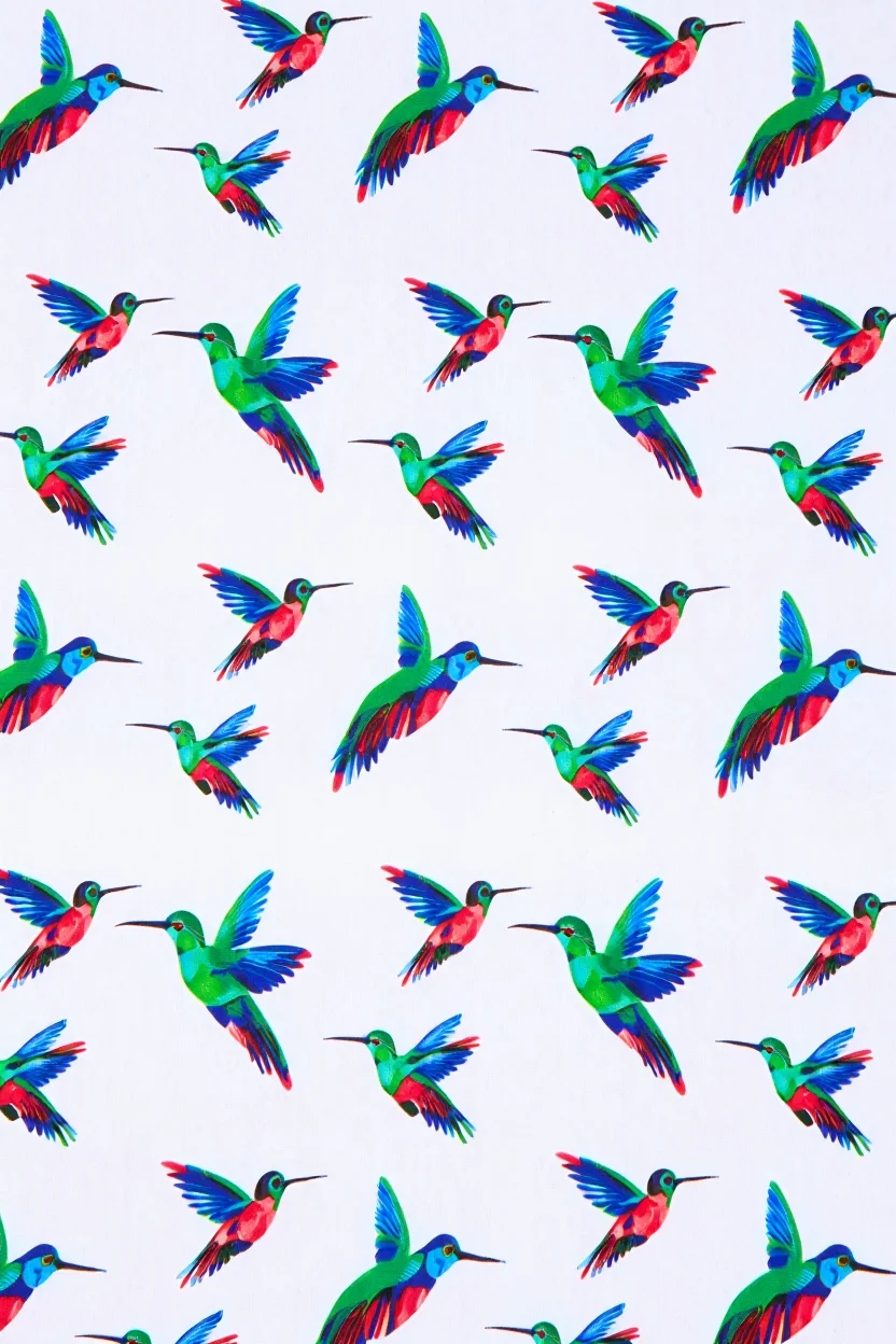 A square bandana textile features a repeating pattern of colorful hummingbirds in flight against a white background. Each hummingbird is rendered in vibrant jewel tones of emerald green, sapphire blue, and ruby red, with distinctive long beaks and hovering wings spread wide. The hummingbirds are arranged in a symmetrical grid pattern across the fabric, with each bird positioned at regular intervals, creating a cohesive decorative design that extends to all four corners of the bandana. Close-up product photography with flat lay composition and even lighting to showcase fabric pattern details.